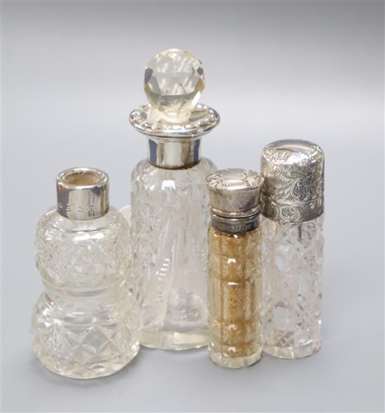 A late Victorian engraved silver mounted glass scent bottle, C.C. May & Sons, Birmingham, 1890 and three others.